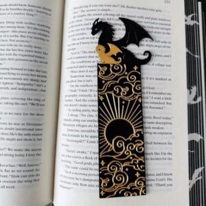Ornate black bookmark featuring dragons and sun