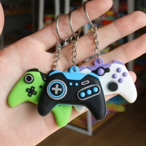 Hand holding three colorful game controller keychains
