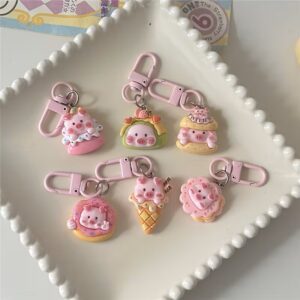 Pastel pig dessert keychains on scalloped dish