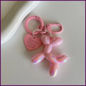 Iridescent pink pup-shaped charm on keyring