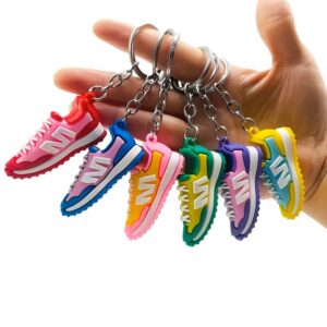 Hand holding colorful sneaker-shaped keychains